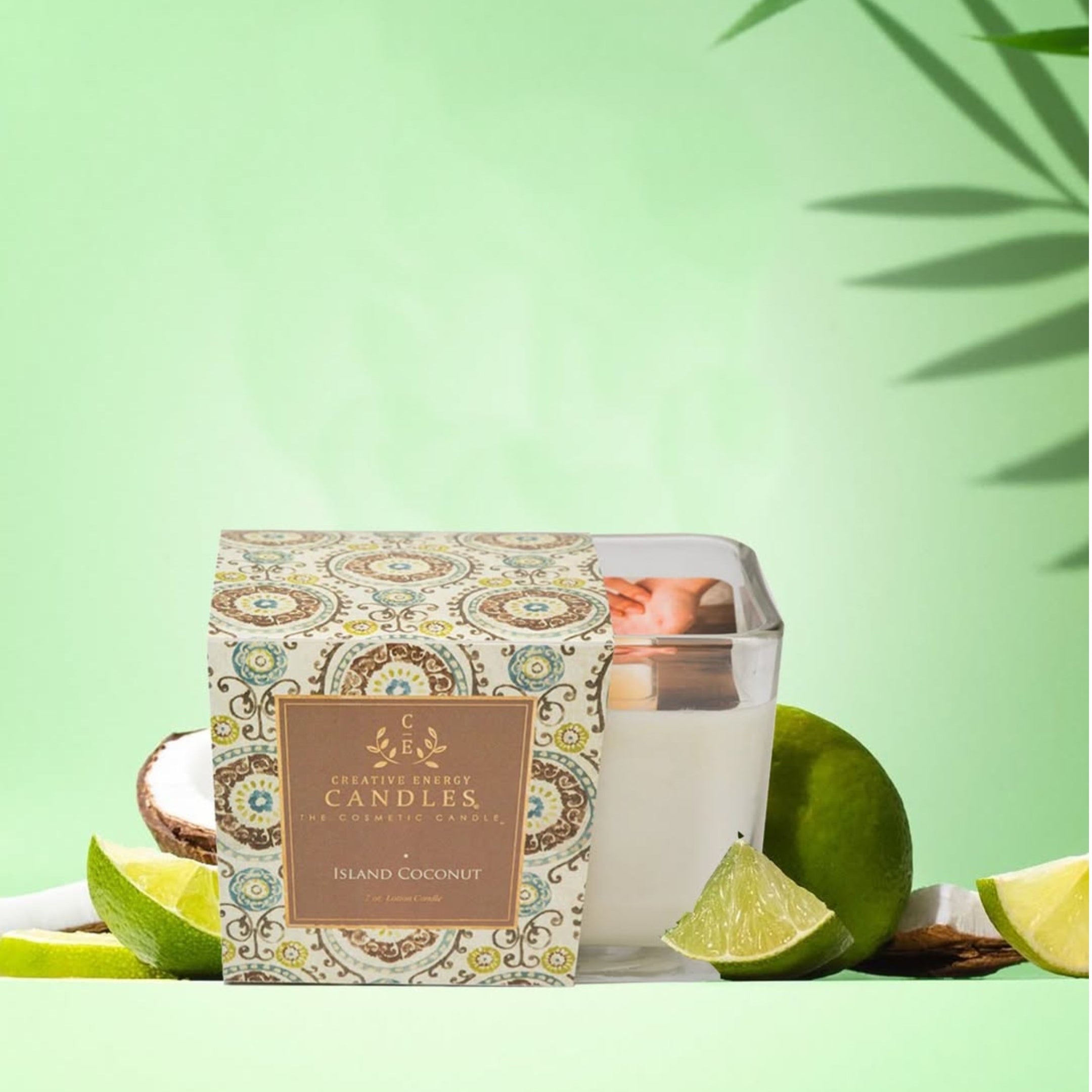 Candle in a decorative box with coconut and lime on a green background